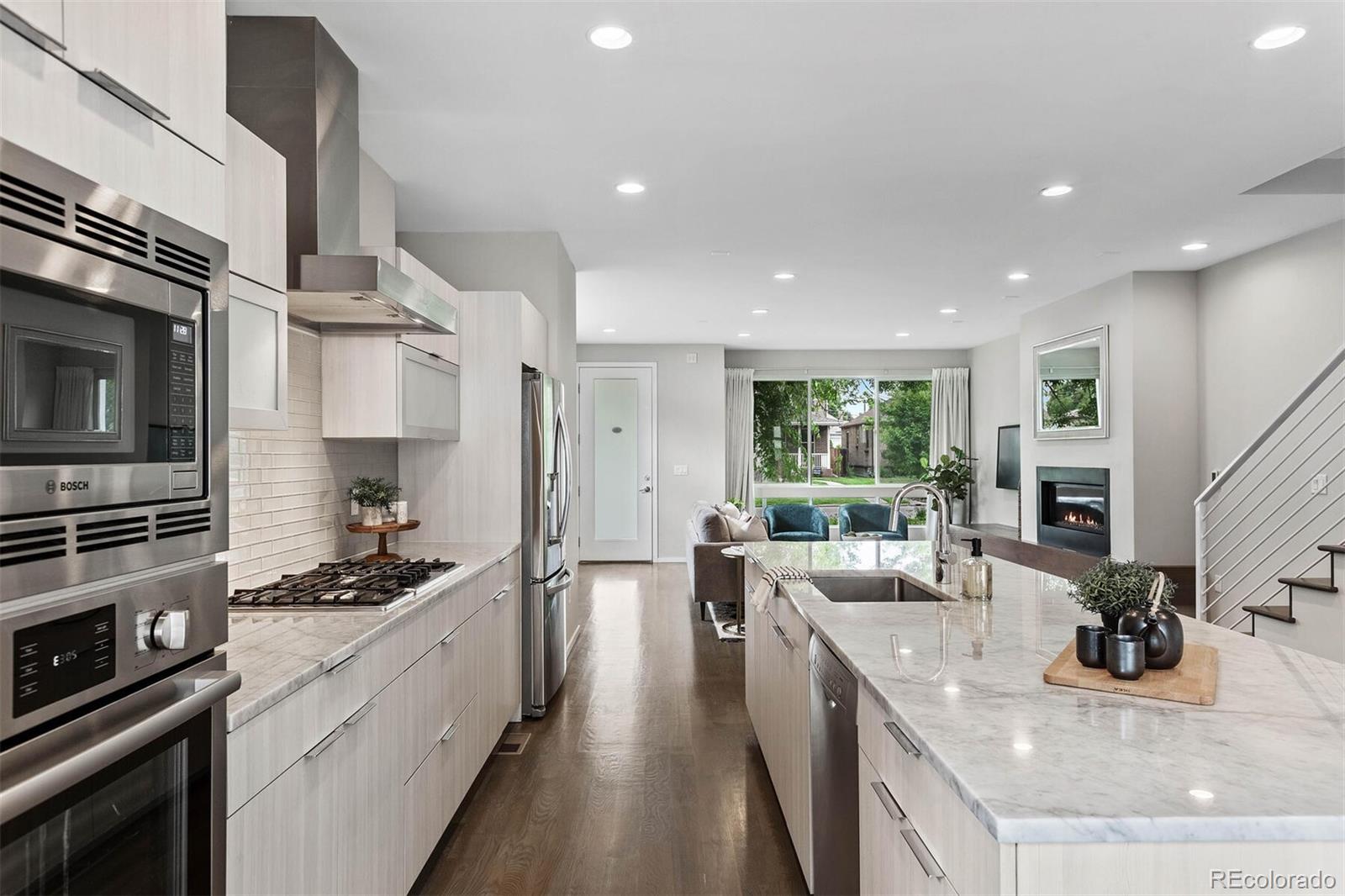 4011 Raleigh Street Denver, CO 80212 - Photo 10 of 34 a kitchen with stainless steel appliances kitchen island granite countertop a stove and a sink