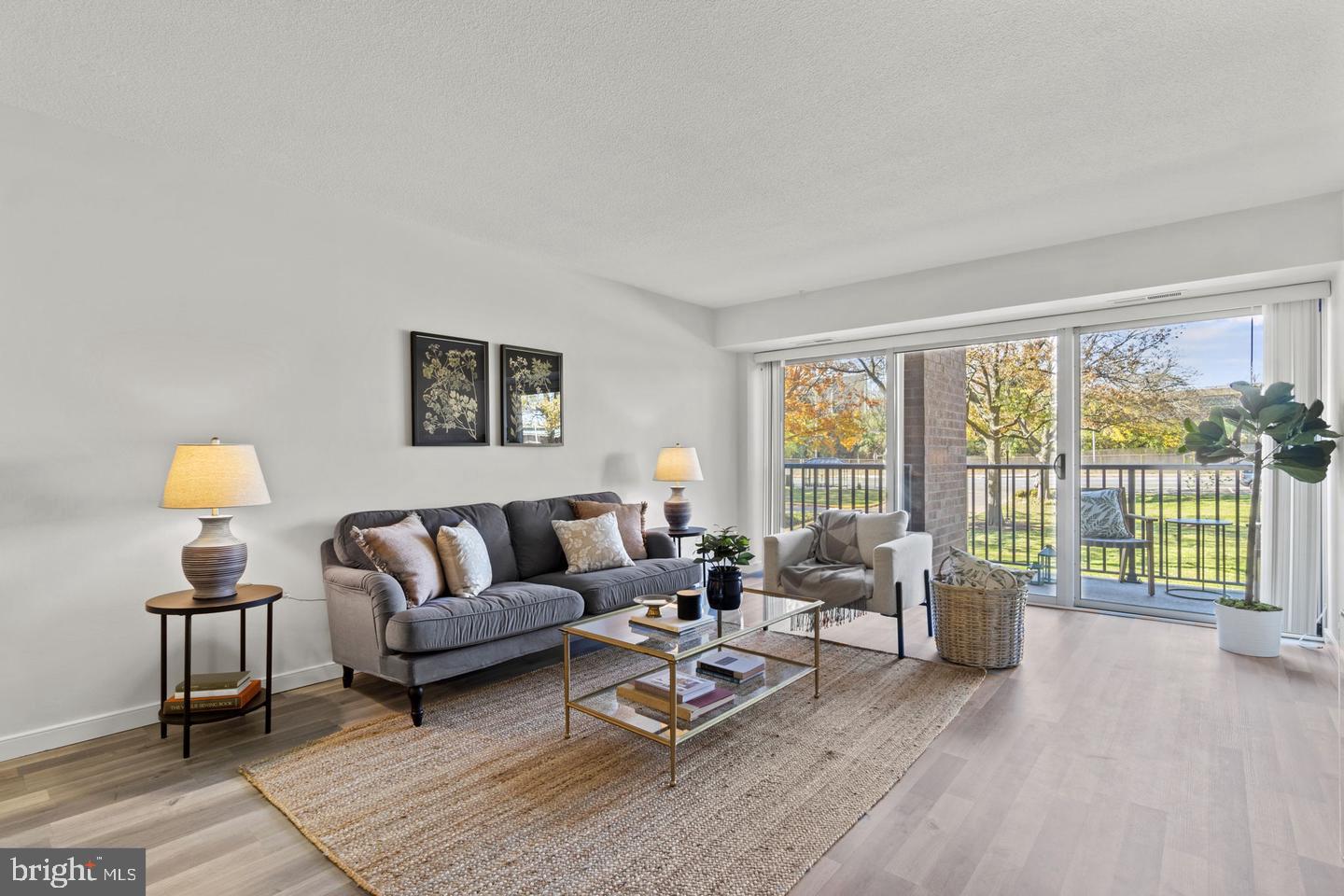 1300 Army Navy Drive, Unit 104 Arlington, VA 22202 - Photo 1 of 19 a living room with furniture and a large window with outer view