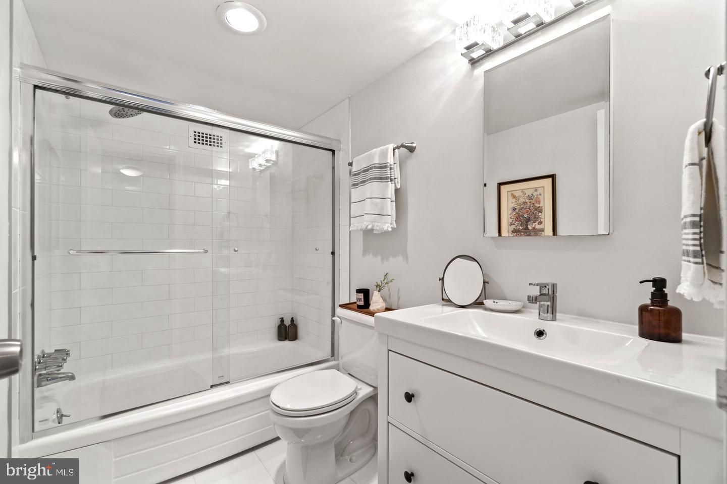 1300 Army Navy Drive, Unit 104 Arlington, VA 22202 - Photo 12 of 19 a bathroom with a sink a toilet and shower