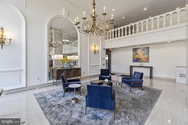 a living room with fireplace furniture and a chandelier