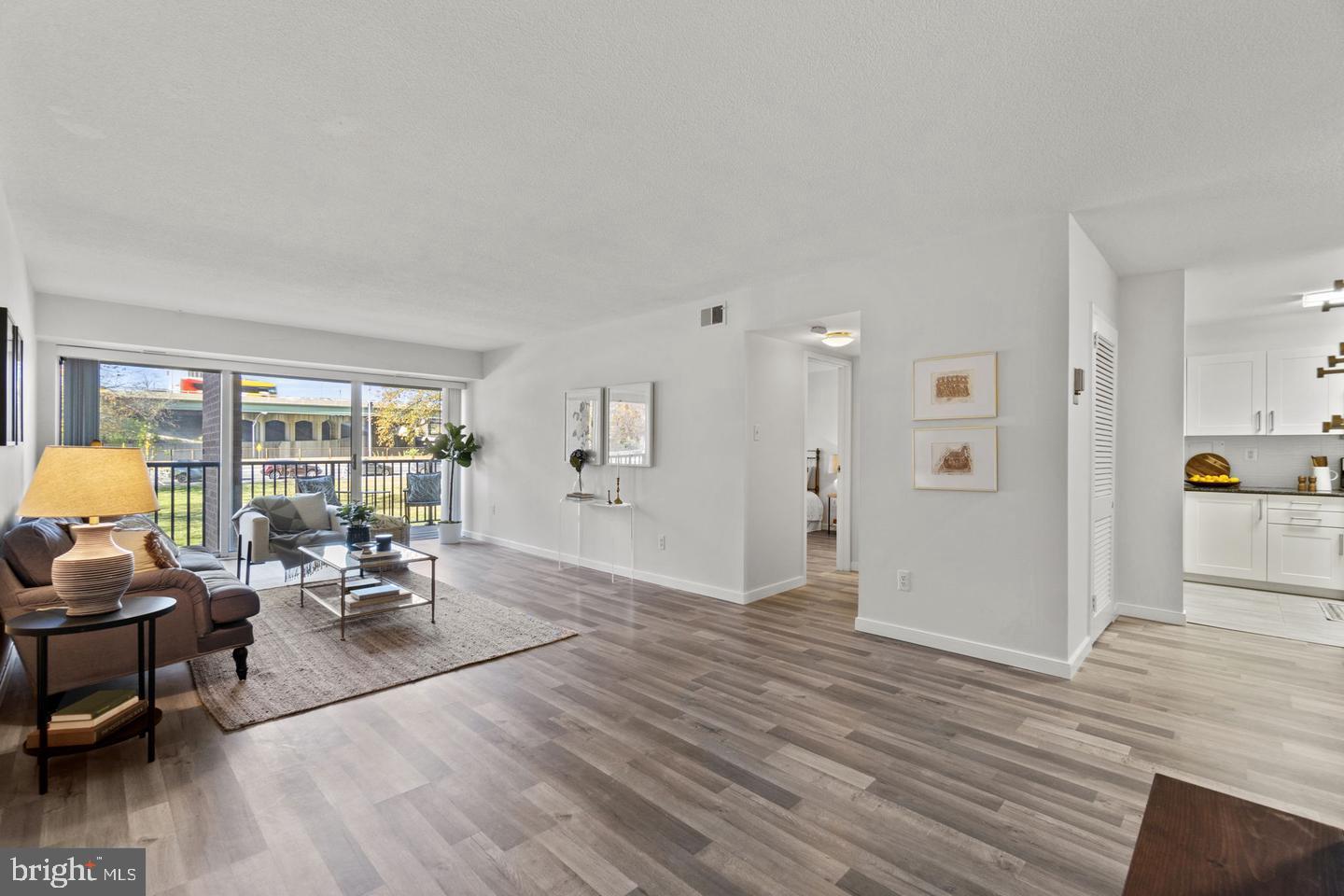 1300 Army Navy Drive, Unit 104 Arlington, VA 22202 - Photo 2 of 19 a living room with furniture and a wooden floor
