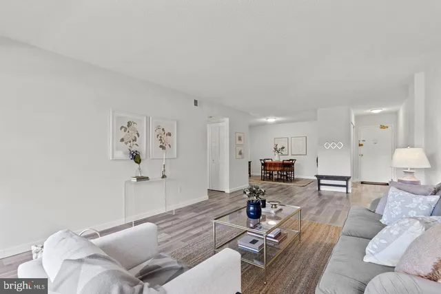 a living room with furniture and kitchen view