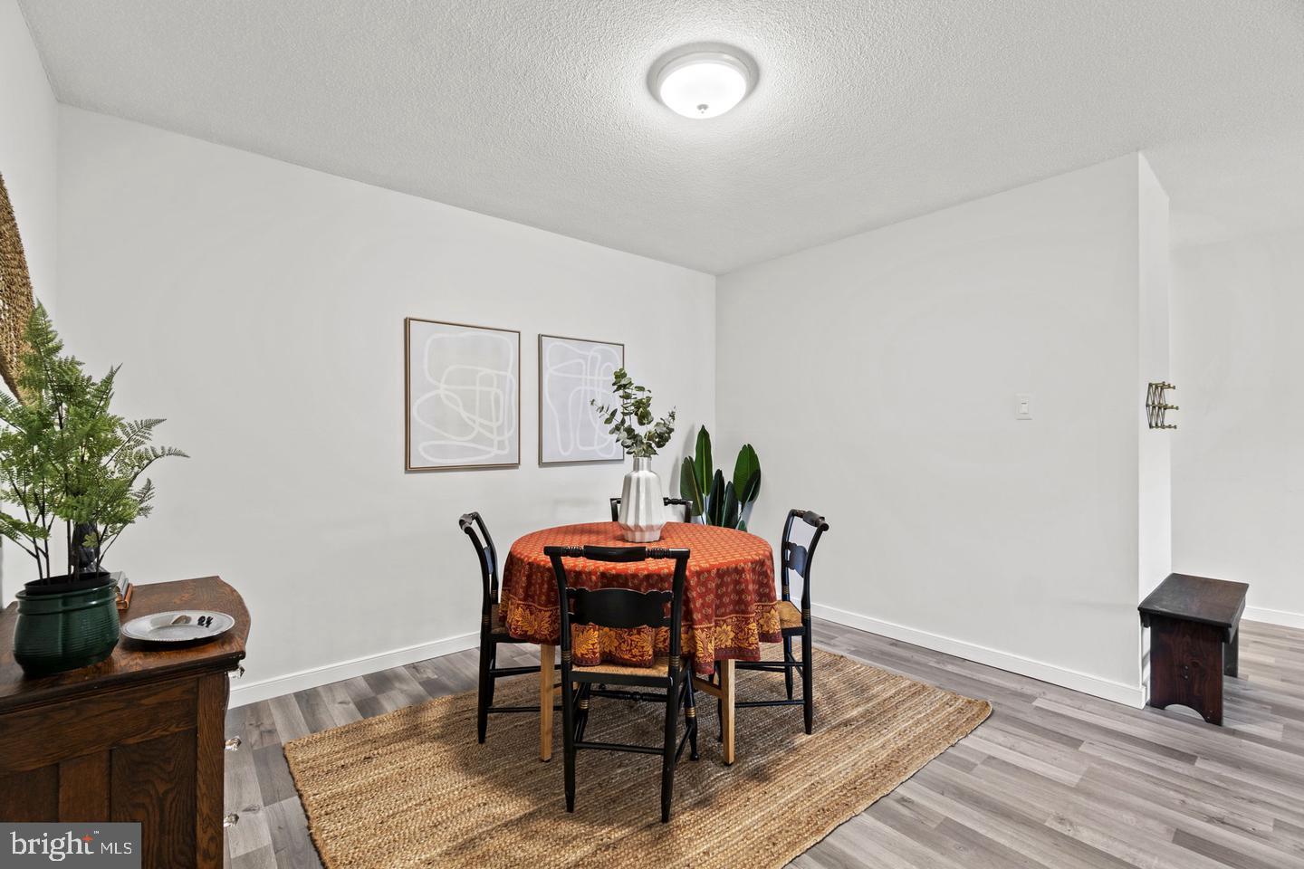 1300 Army Navy Drive, Unit 104 Arlington, VA 22202 - Photo 7 of 19 a dining room with furniture and wooden floor