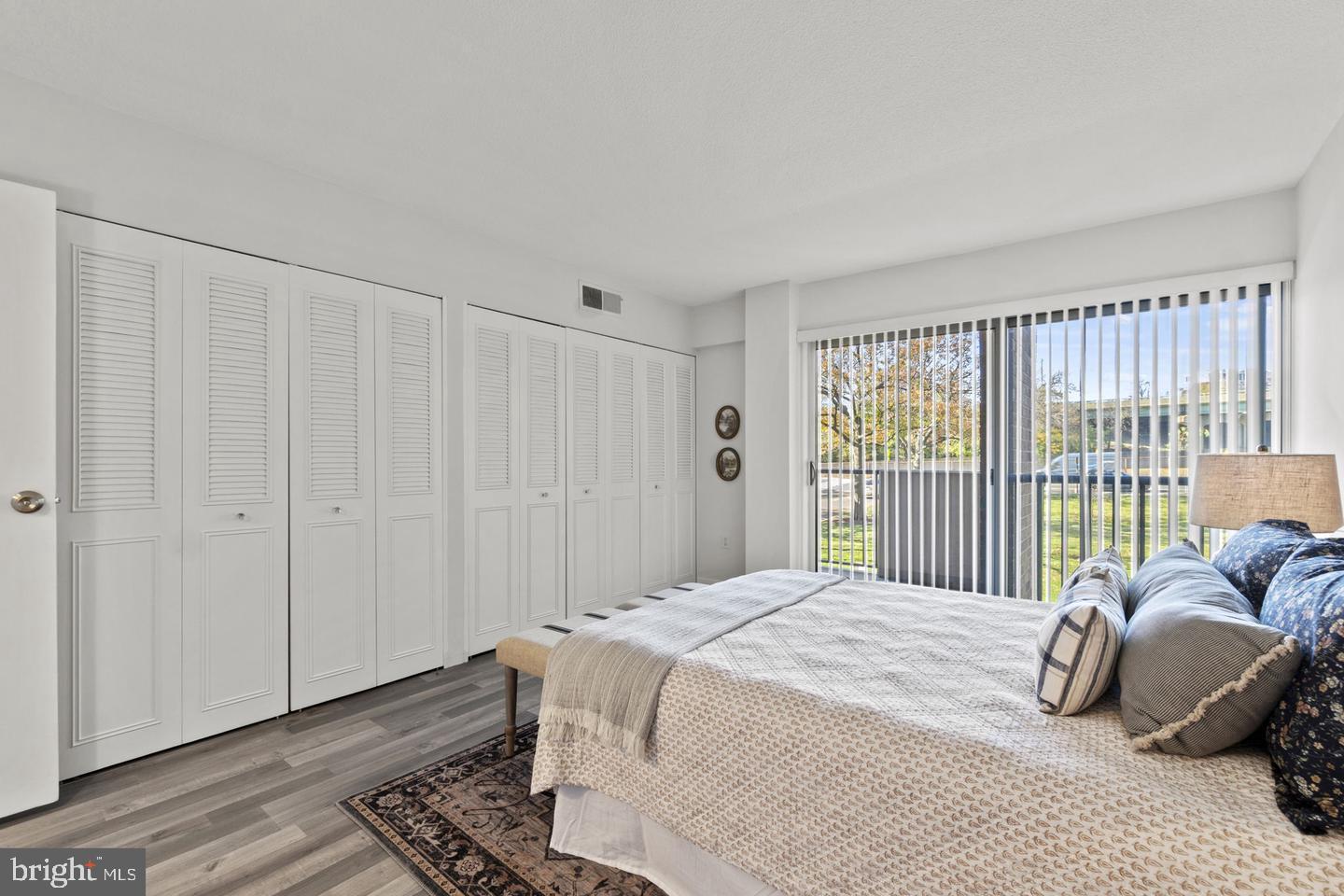 1300 Army Navy Drive, Unit 104 Arlington, VA 22202 - Photo 9 of 19 a spacious bedroom with a bed and a window
