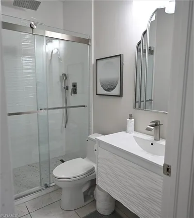 a bathroom with a toilet sink and shower