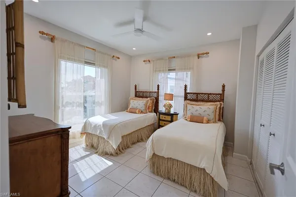 a bedroom with two beds and a window