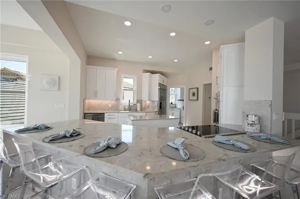 a kitchen with stainless steel appliances granite countertop a sink and a stove