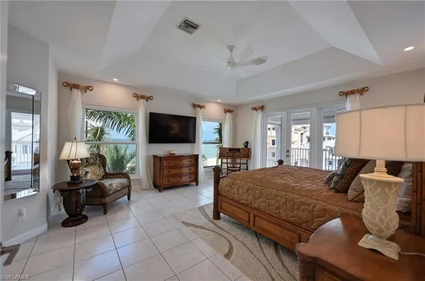 a bedroom with furniture and a flat screen tv