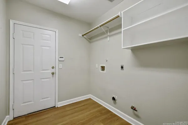 a view of a room with wooden floor