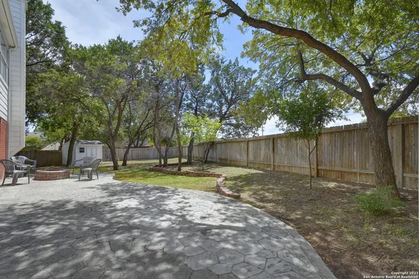 a backyard of a house with trees and plants