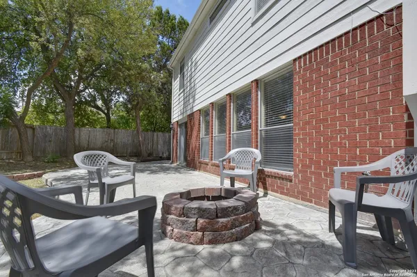 a view of a patio with couple of chairs