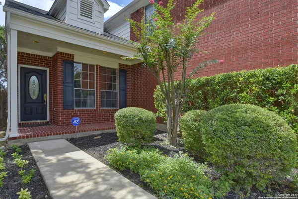 a view of a chair and table in the patio with potted plants