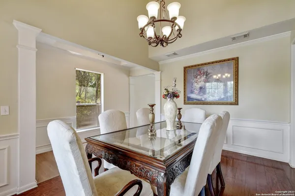 a view of a dining room with furniture wooden floor and chandelier