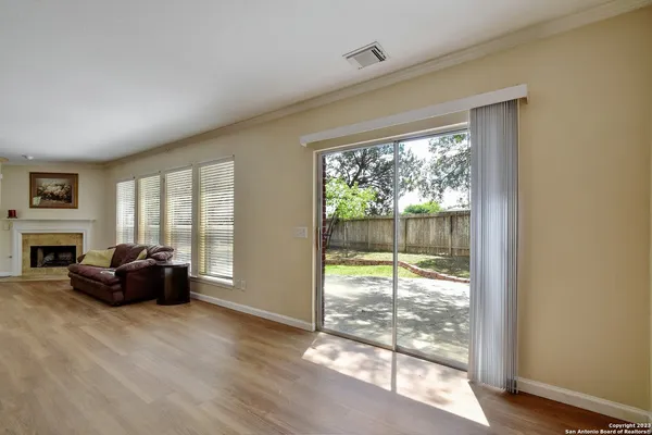 a living room with furniture a fireplace and a large window