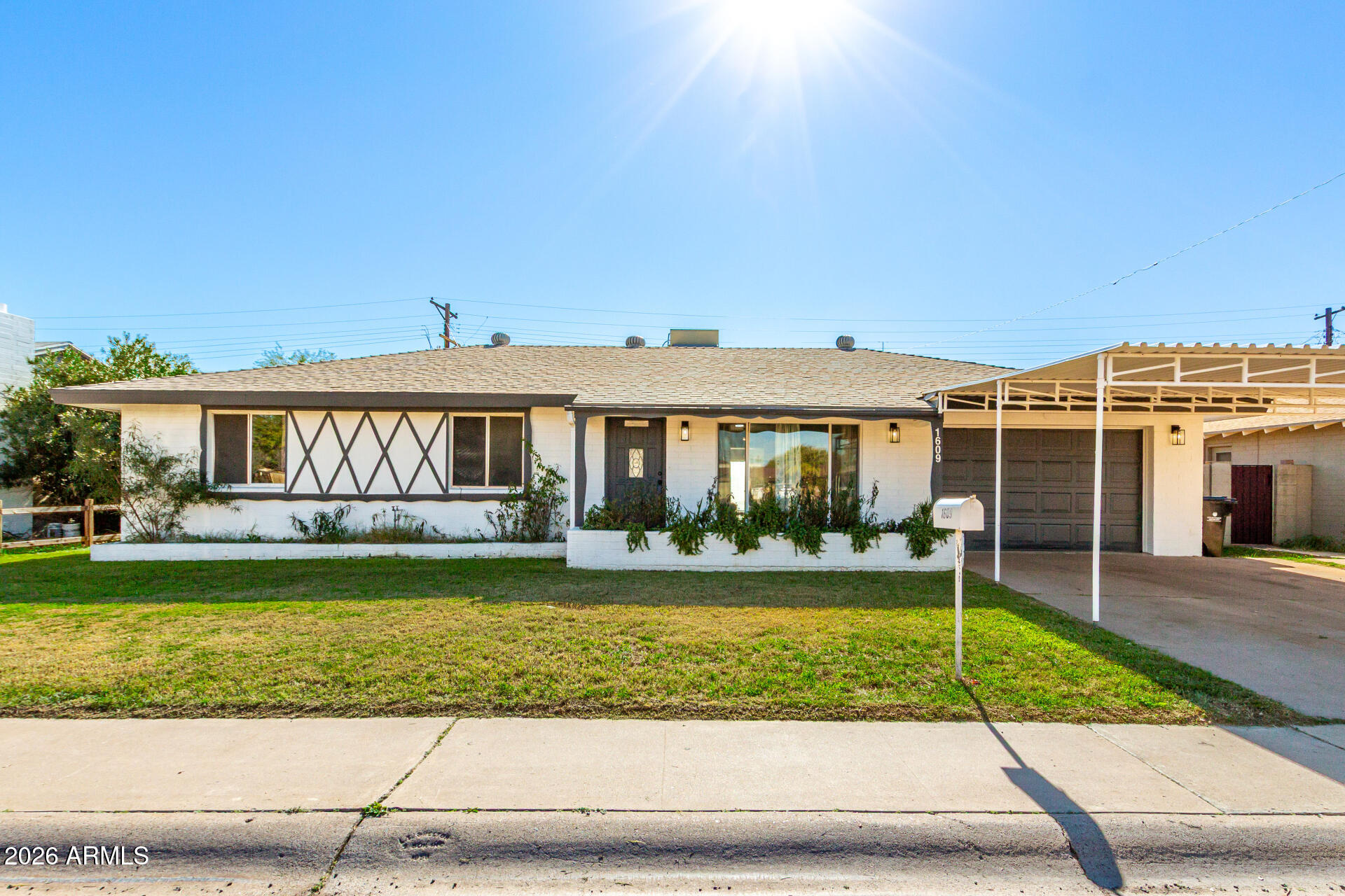 a view of a house with a yard and plants