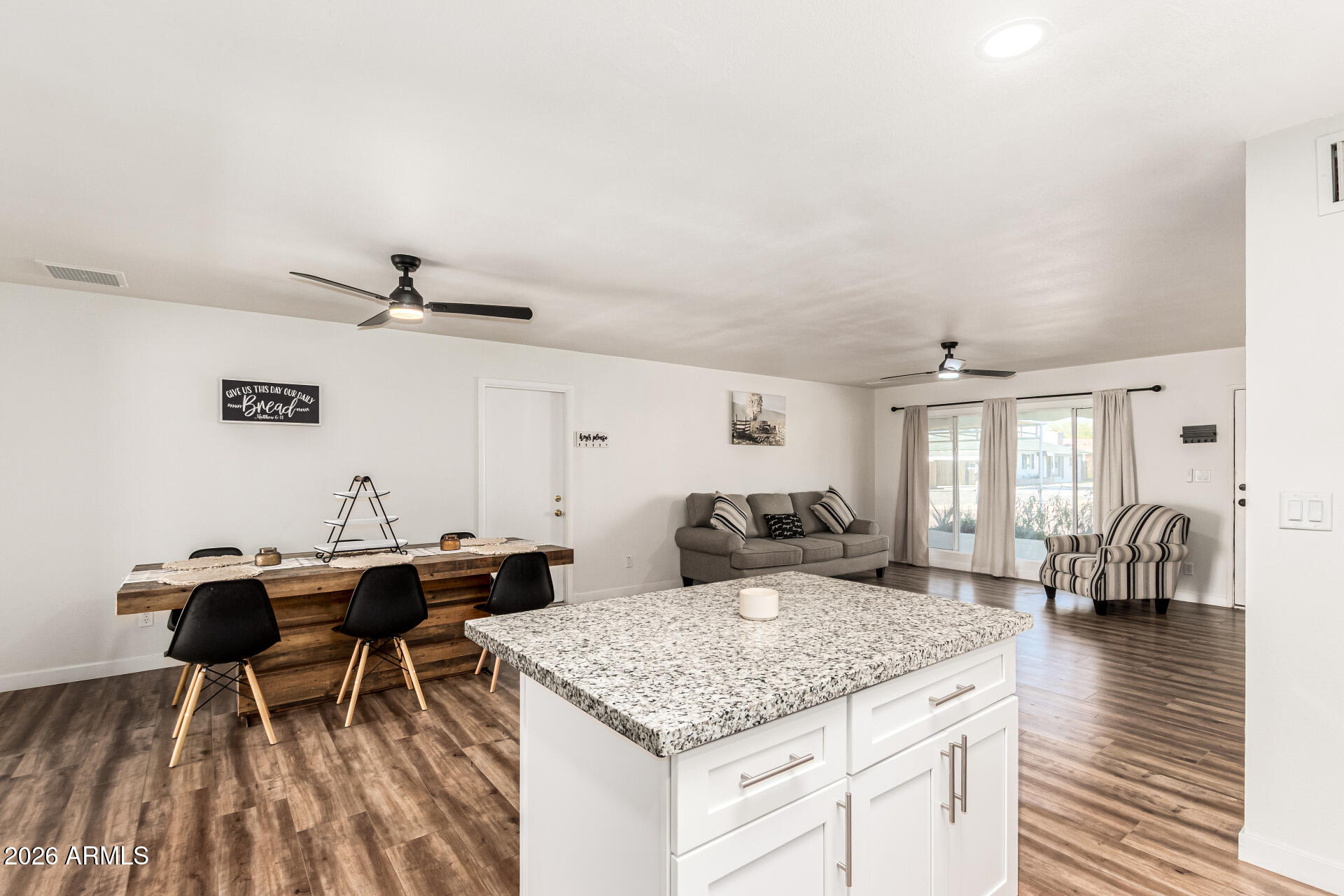 1609 West Mission Lane Phoenix, AZ 85021 - Photo 14 of 36 a living room with a table chairs and a wooden floor