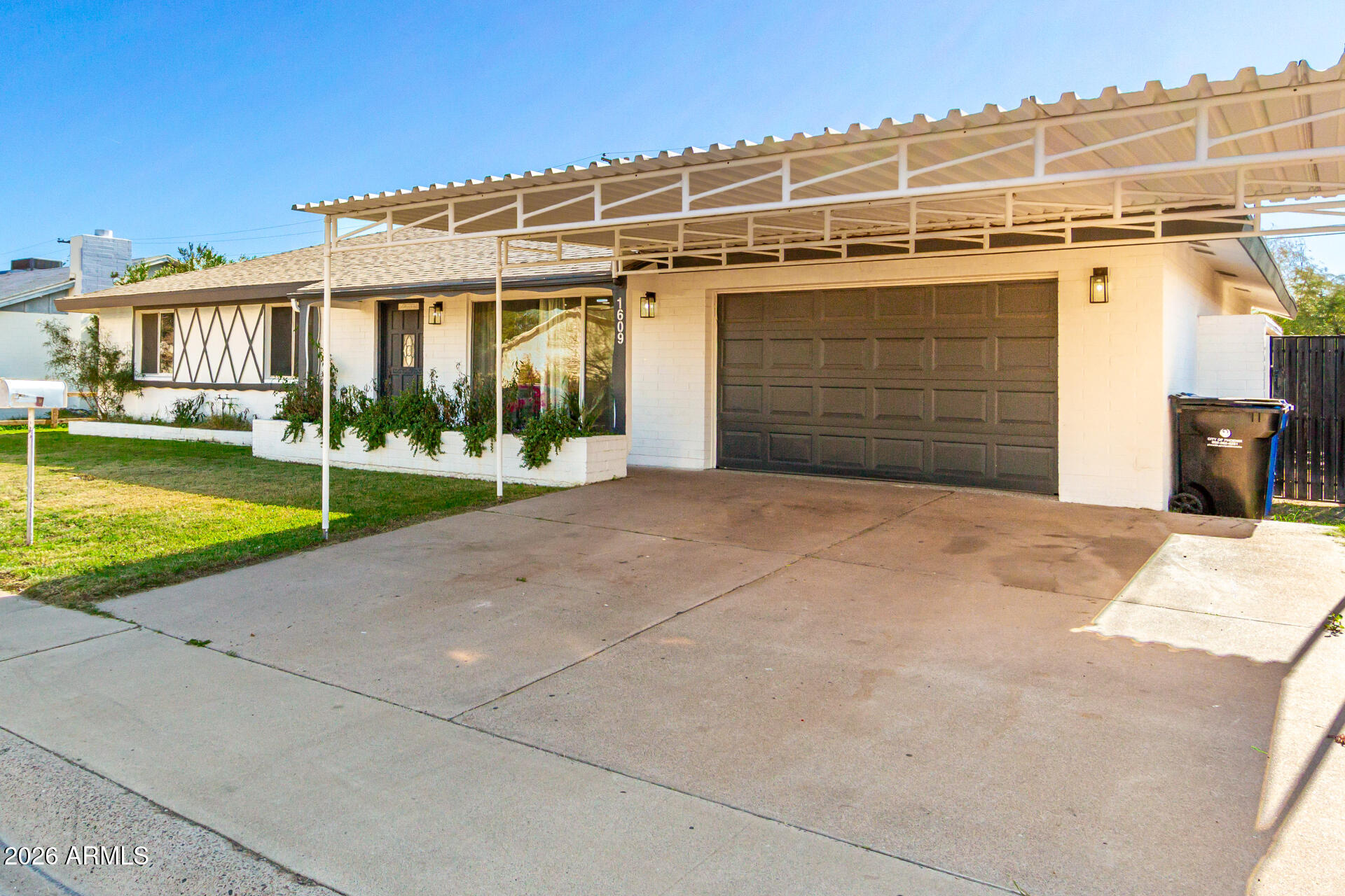 1609 West Mission Lane Phoenix, AZ 85021 - Photo 35 of 36 a view of a house with a yard and garage