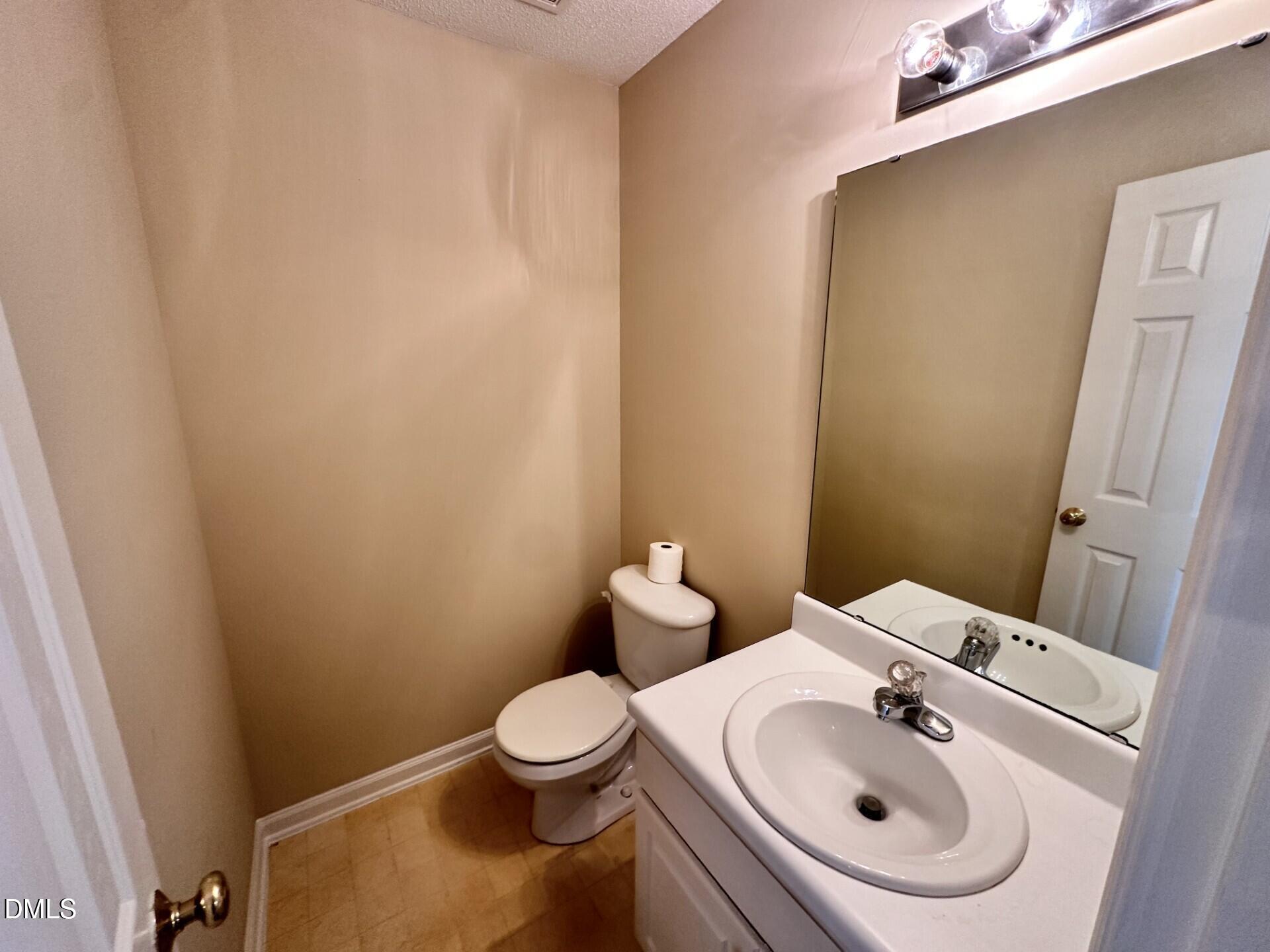 2112 Walnut Bluffs Lane Raleigh, NC 27610 - Photo 12 of 17 a white toilet sitting next to a bathroom sink