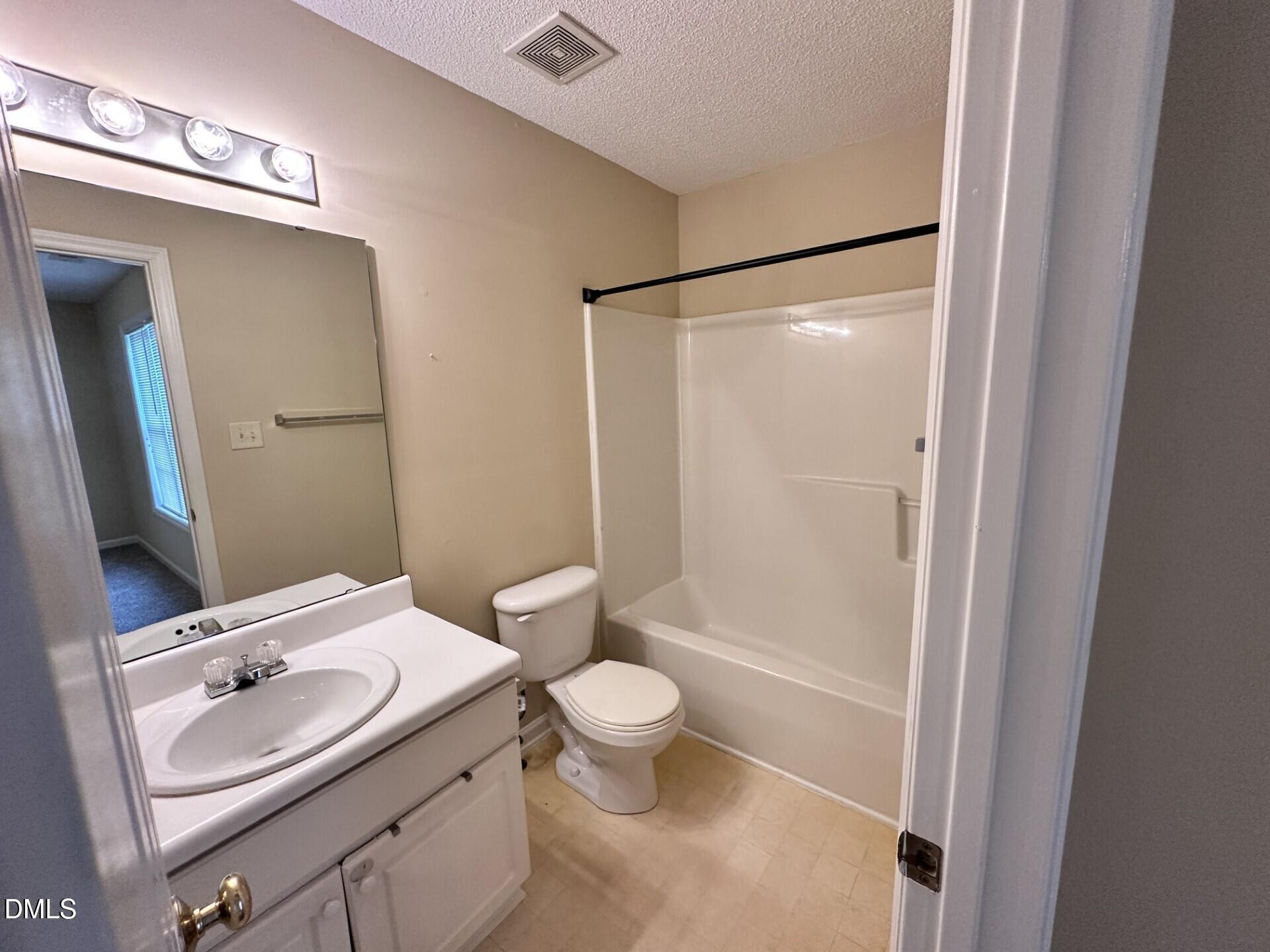 2112 Walnut Bluffs Lane Raleigh, NC 27610 - Photo 14 of 17 a bathroom with a sink a toilet and shower