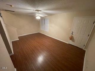 2112 Walnut Bluffs Lane Raleigh, NC 27610 - Photo 2 of 17 a view of an empty room with wooden floor