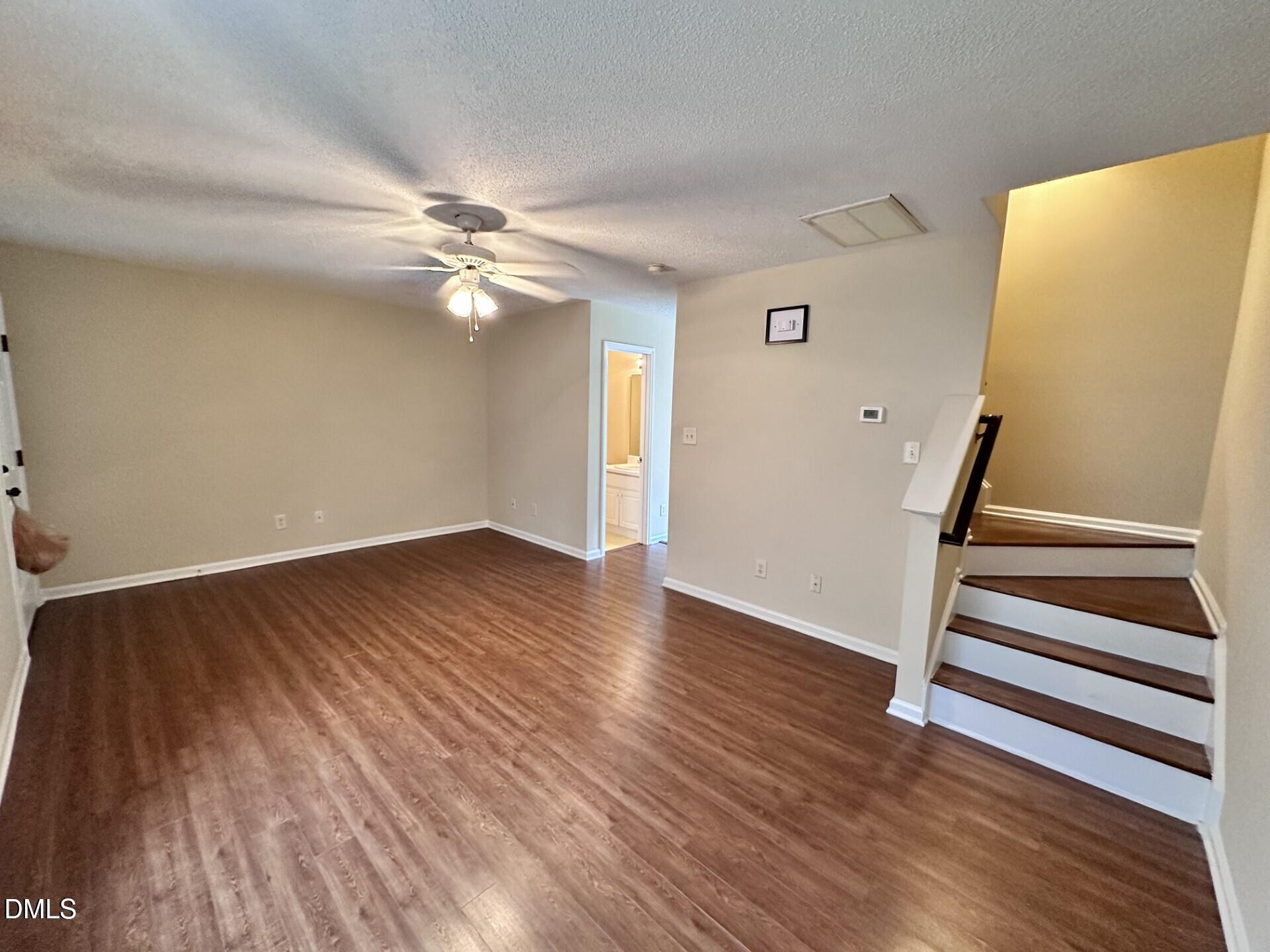 2112 Walnut Bluffs Lane Raleigh, NC 27610 - Photo 3 of 17 wooden floor in an empty room with a window
