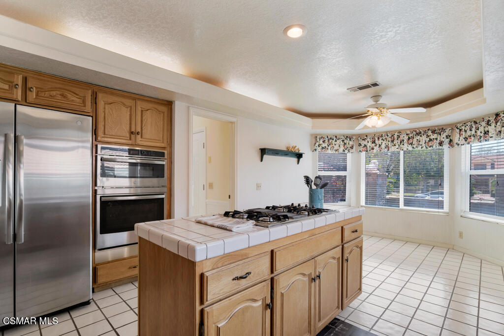 5339 Seneca Place Simi Valley, CA 93063 - Photo 22 of 76 a kitchen with a refrigerator a stove a sink and a cabinets