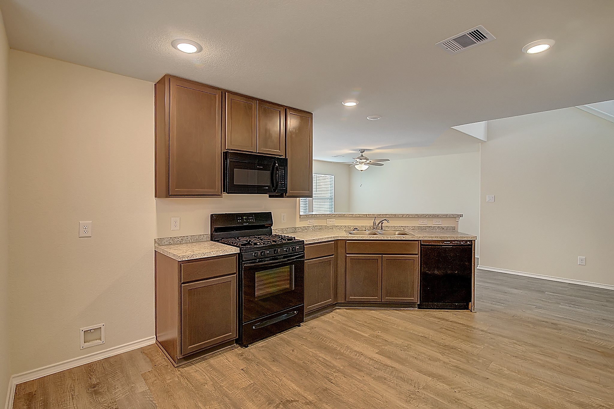 14417 Conifer Drive Conroe, TX 77302 - Photo 5 of 20 a kitchen with stainless steel appliances granite countertop a stove and a sink