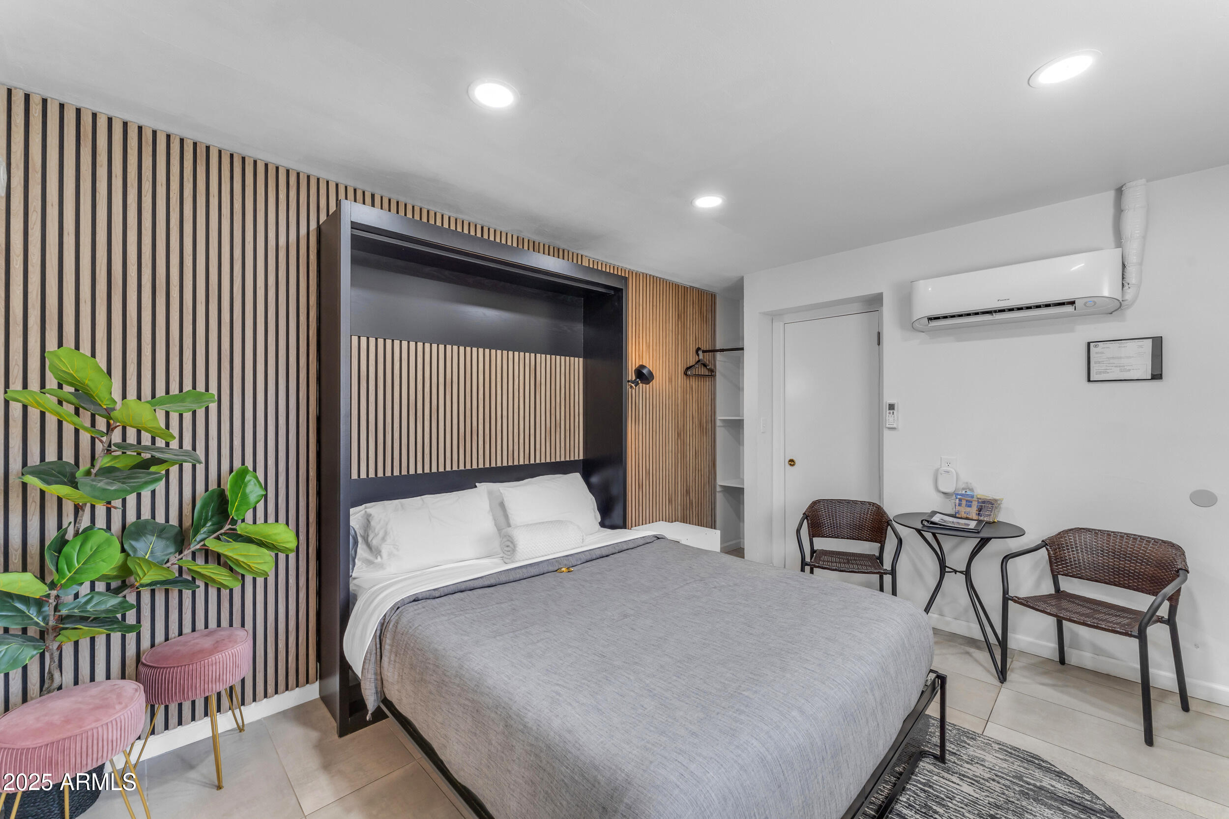 6943 East Granada Road Scottsdale, AZ 85257 - Photo 14 of 19 a bed room with a bed and a chair