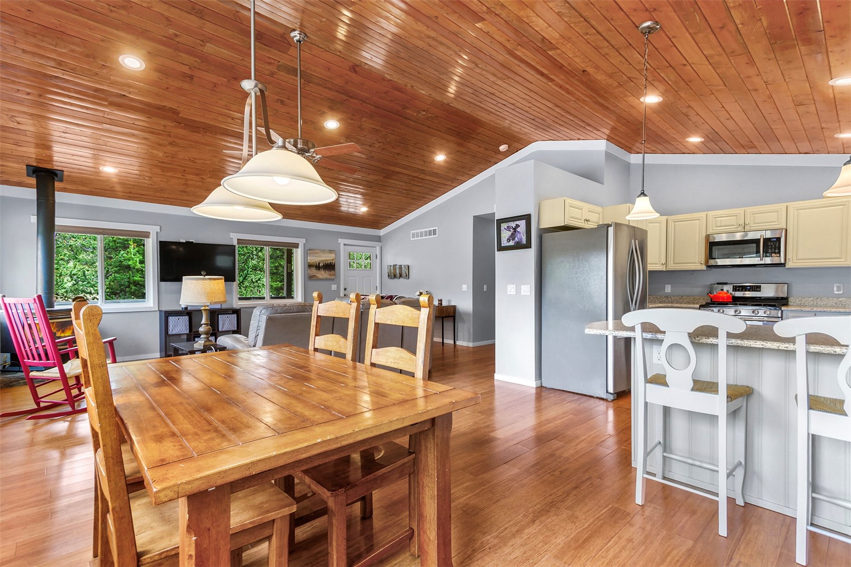 485 High Creek Road Fairplay, CO 80440 - Photo 1 of 32 Dining space with wooden ceiling, lofted ceiling, light wood-style floors, a wood stove, and ornamental molding