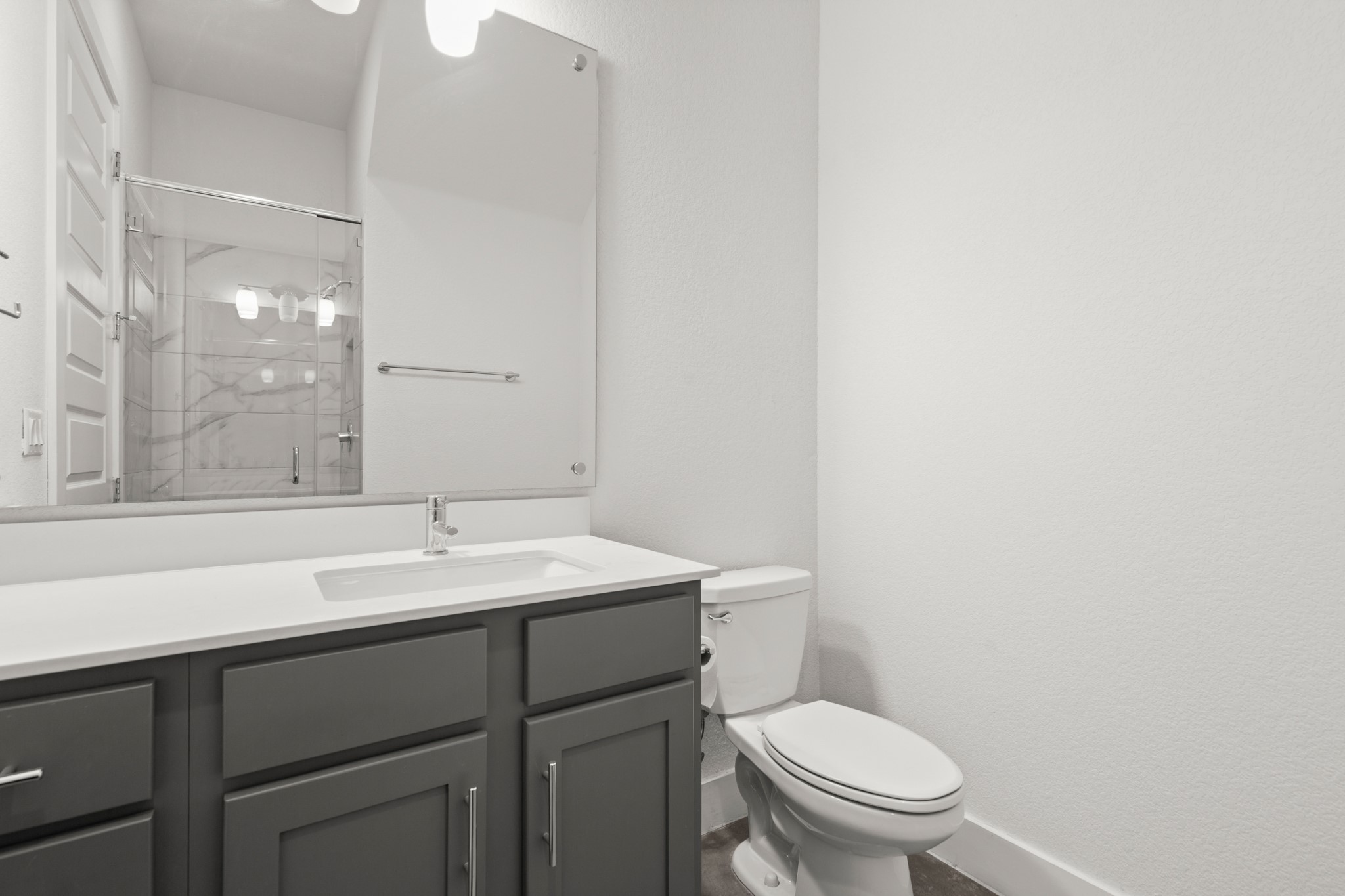 8922 Manchaca Road, Unit 701 Austin, TX 78748 - Photo 12 of 25 a bathroom with a toilet a sink a mirror and vanity