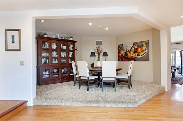 a living room with furniture and painting on the wall
