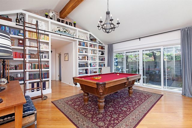 a room with pool table and windows