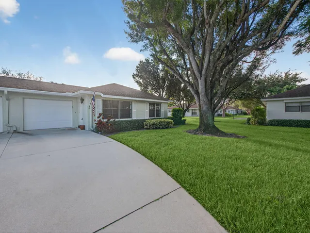 a view of house with a yard