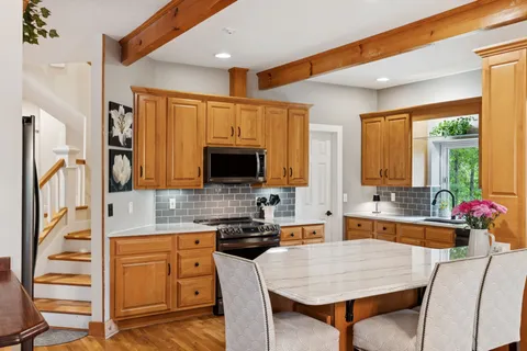 a kitchen with stainless steel appliances granite countertop a refrigerator and a stove top oven