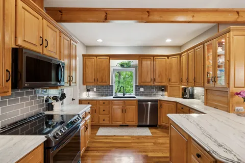 a bathroom with a sink toilet vanity and shower