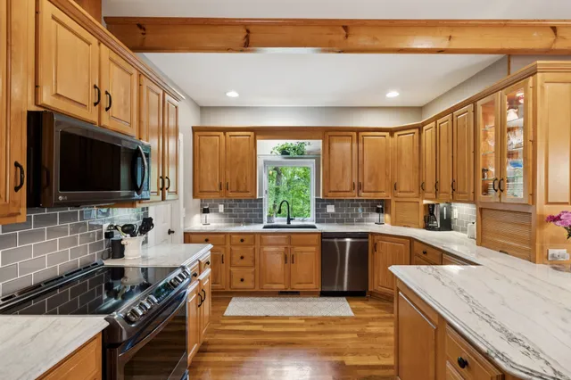 a bathroom with a sink toilet vanity and shower