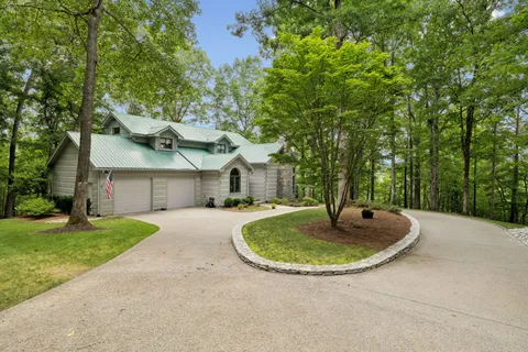 a view of a house with pool and a yard