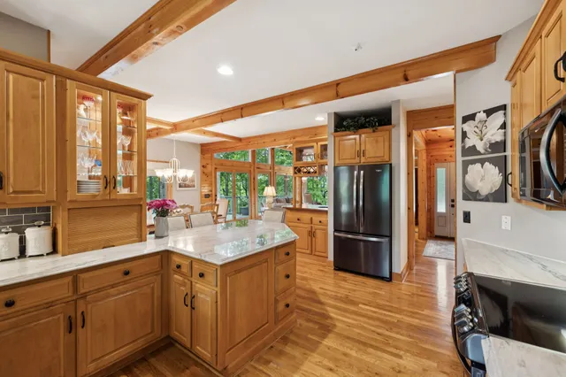 a bedroom with a bed and large windows