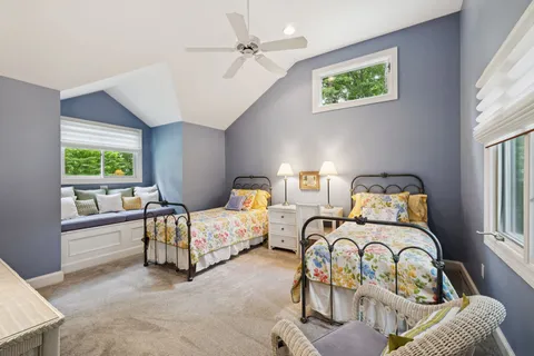 a bathroom with a double vanity sink toilet and a mirror