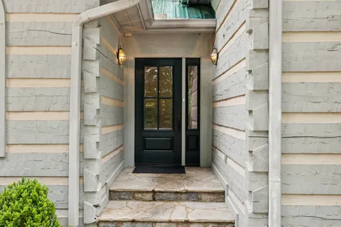 a living room with furniture a fireplace and a large window