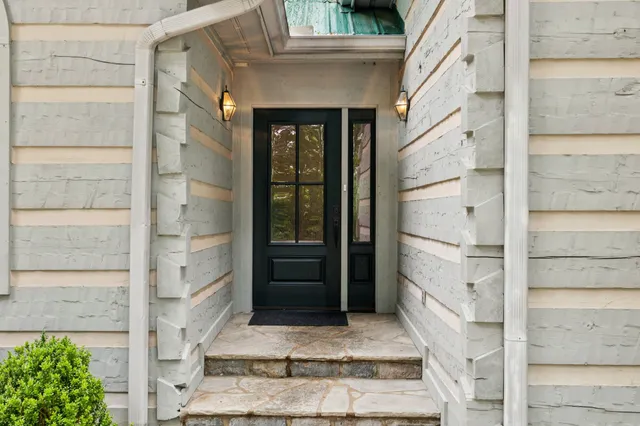 a living room with furniture a fireplace and a large window