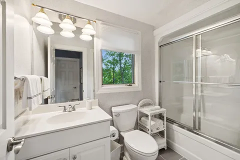 a bathroom with a glass shower door