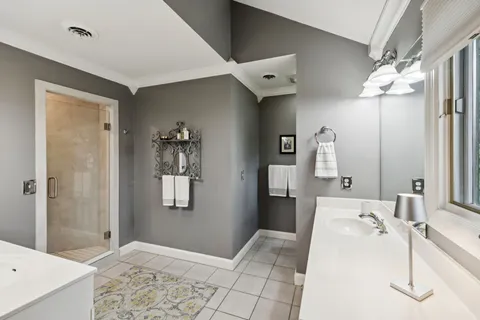 a view of a house with backyard and a tree