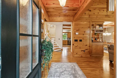 a living room with furniture a fireplace and a chandelier