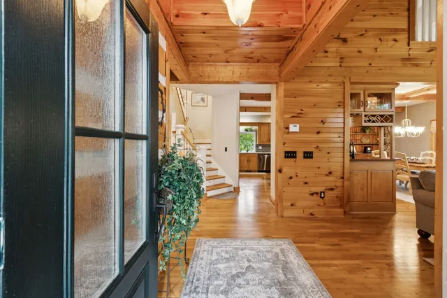 a living room with furniture a fireplace and a chandelier