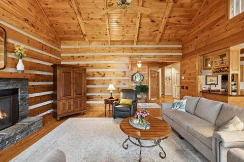 a dining room with furniture wooden floor and a rug