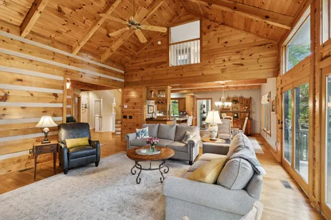 a bedroom with furniture and a floor to ceiling window
