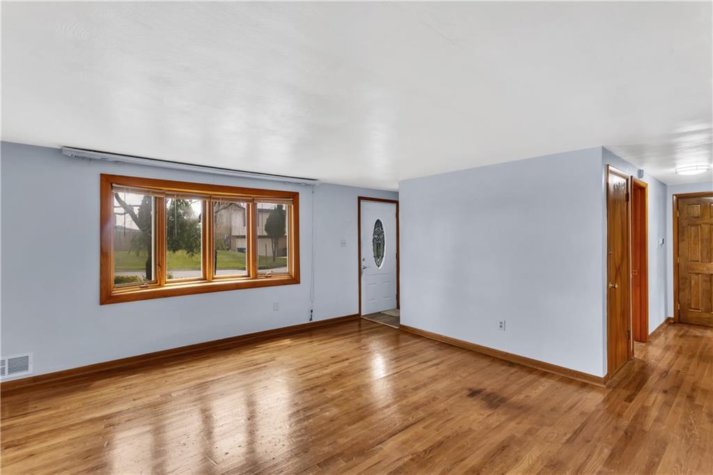 51 Revo Road Pittsburgh, PA 15236 - Photo 6 of 38 The large bay window fills the living room with soft, natural light.
