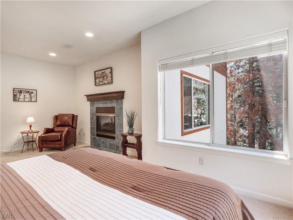1368 Zurich Lane Incline Village, NV 89451 - Photo 22 of 34 a bedroom with a bed and a dresser next to a window