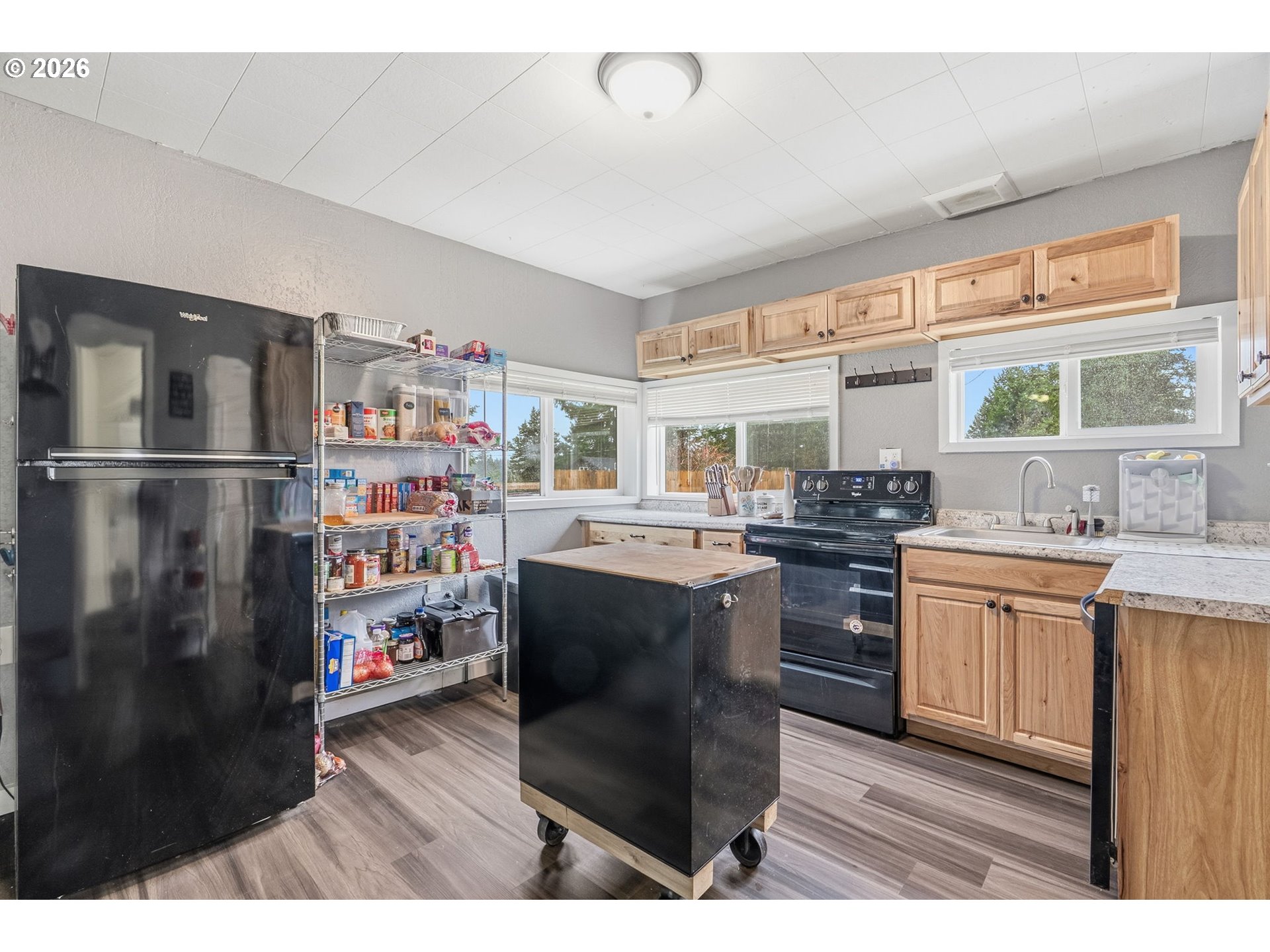 228 Holcomb Spur Road Kelso, WA 98626 - Photo 7 of 23 a kitchen with stainless steel appliances granite countertop a refrigerator a stove a sink dishwasher and white cabinets with wooden floor